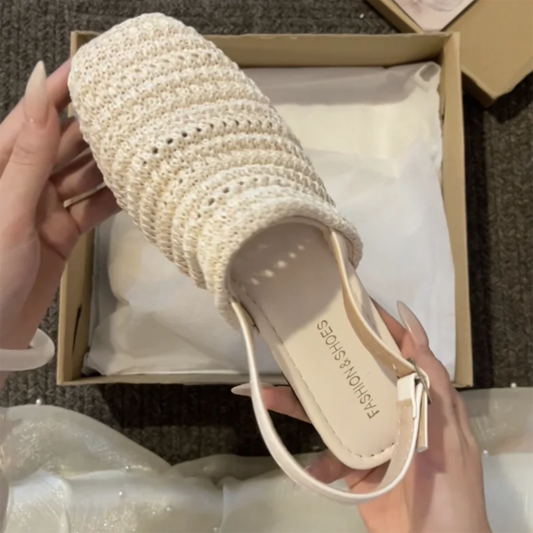 Beige woven sandal held above a box with 'Fashionable Shoes' branding.