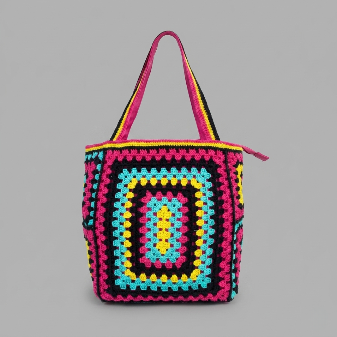 Purple crocheted bag with a geometric pattern on a gray background