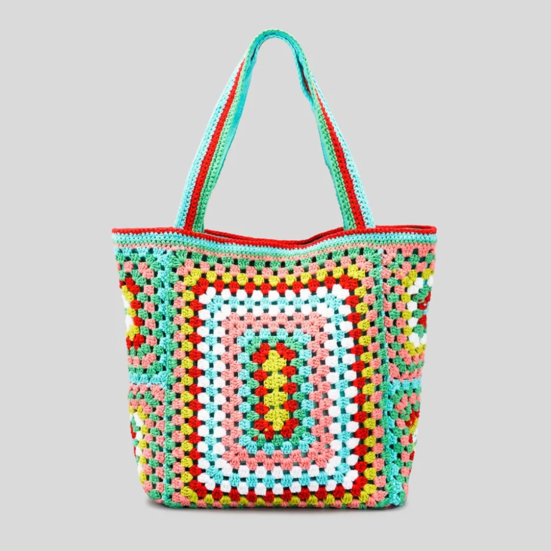 Green crocheted bag with a geometric pattern on a gray background