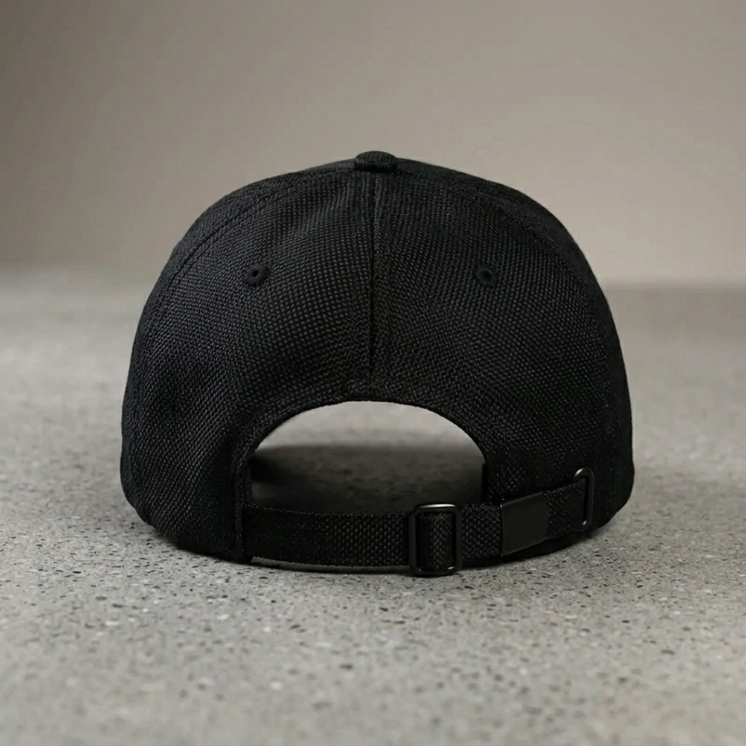 Black cap on a gray surface with a neutral background