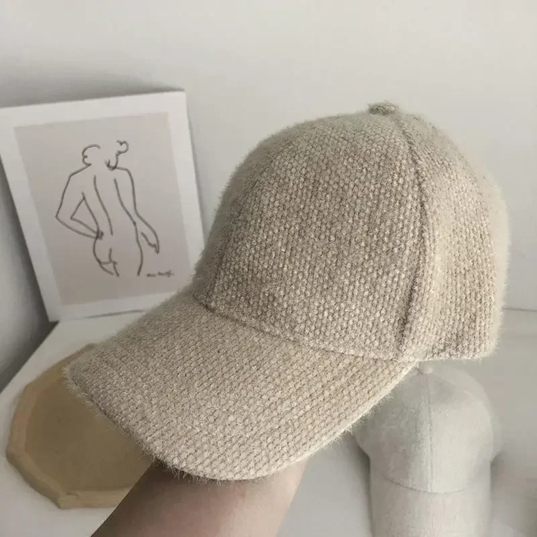 Khaki textured baseball cap on a mannequin head with a minimal background