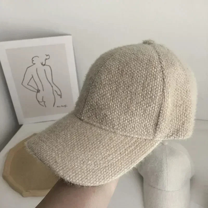 Khaki textured baseball cap on a mannequin head with a minimal background