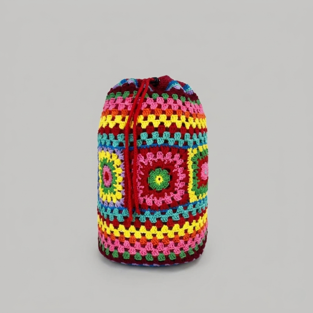 Rose red crocheted drawstring bag on a gray background