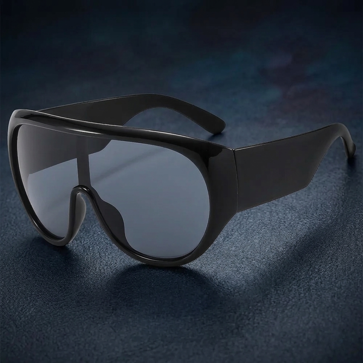 Black sunglasses with a reflective surface on a dark background