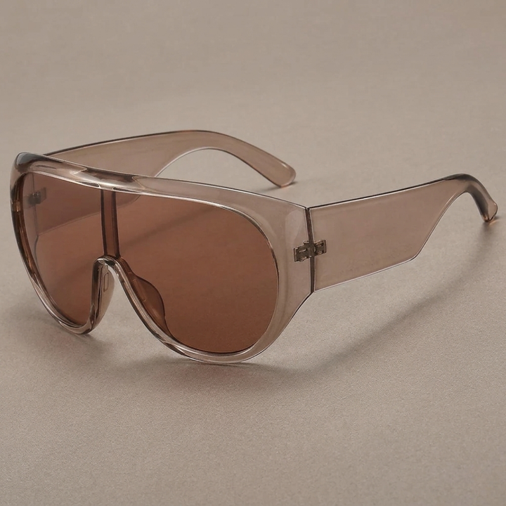 Sunglasses with red tea lenses and clear frame on a beige background