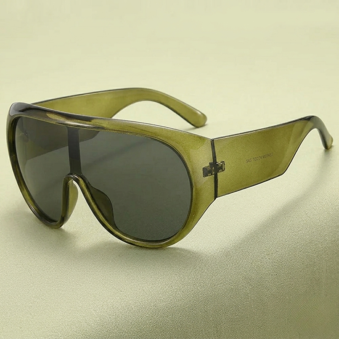 Sunglasses with green frame and dark lenses on a beige background