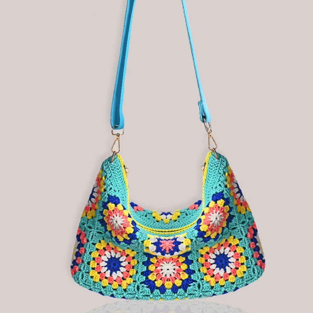 Colorful crocheted handbag with a pattern on a light gray background