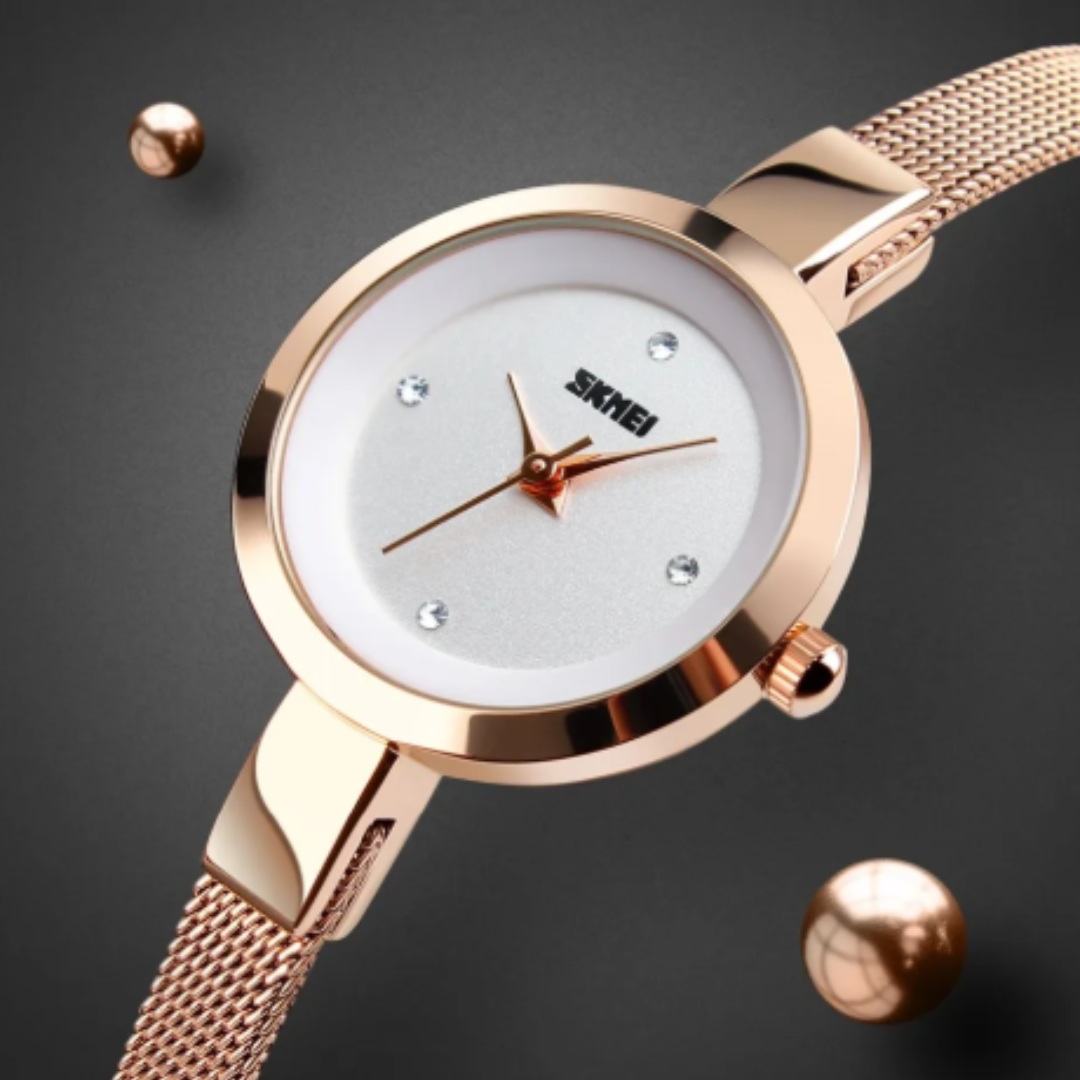 Rose gold watch with a white face on a dark background