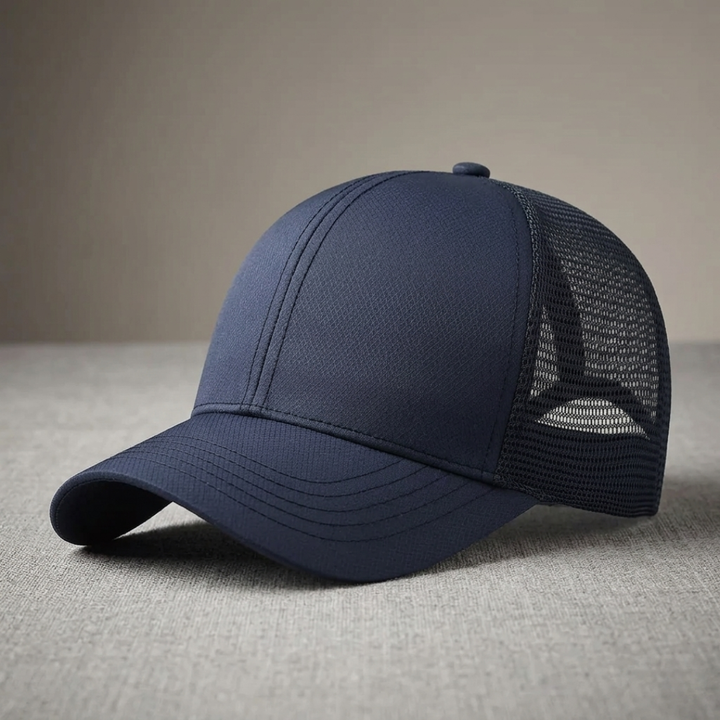 Blue cap with mesh back on a gray surface