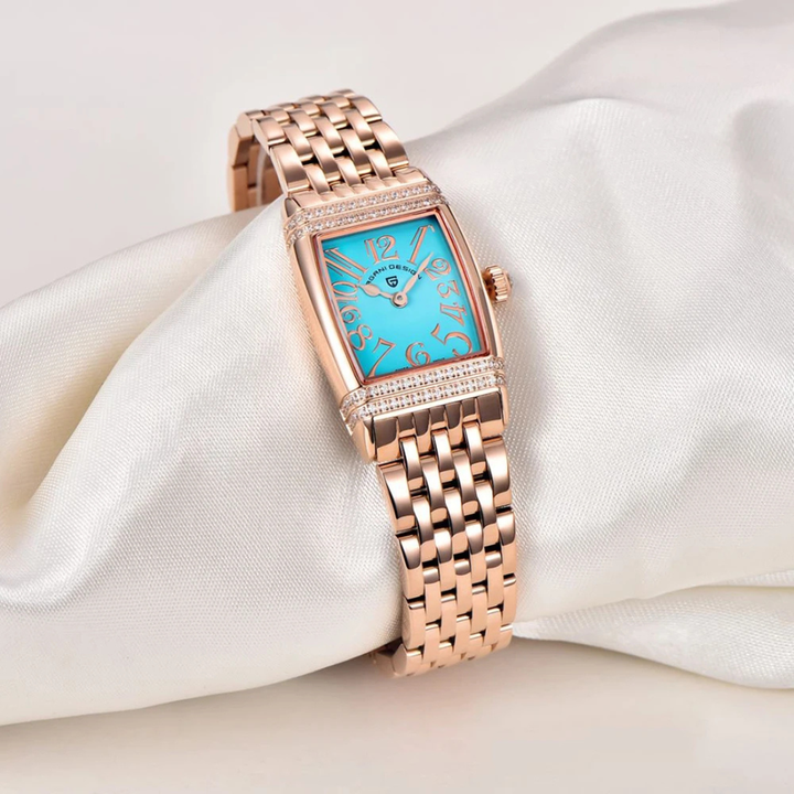 Gold watch with blue face on a white satin background
