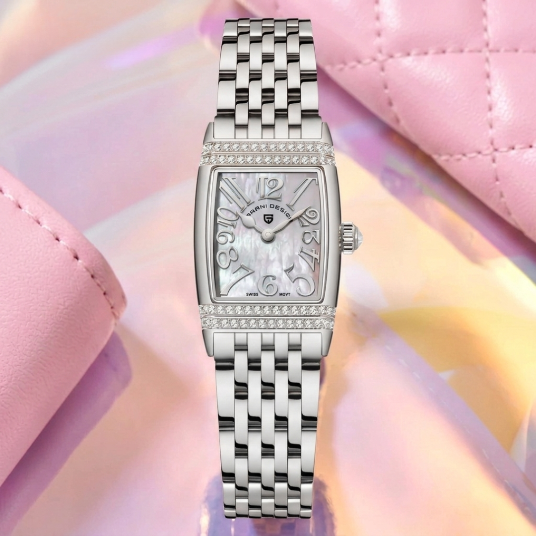 Silver watch with a detailed face on a pink and yellow gradient background