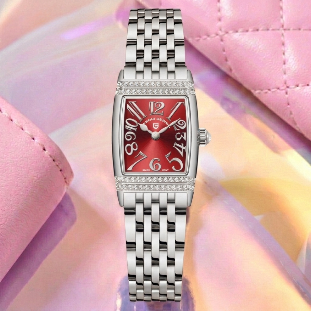 Silver watch with a red face on a pink and yellow gradient background