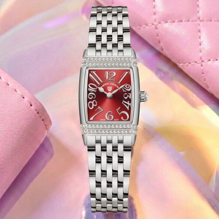 Silver watch with a red face on a pink and yellow gradient background