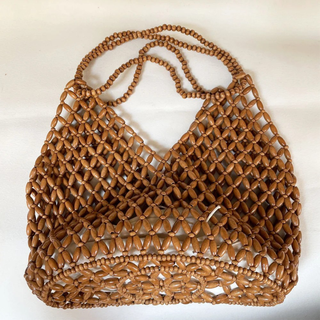 Brown woven handbag on a white background