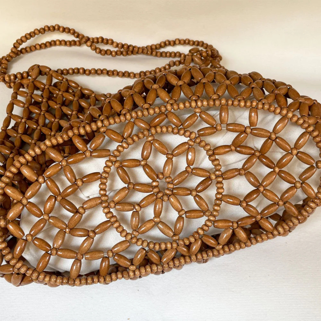 Brown beaded bag on a white background