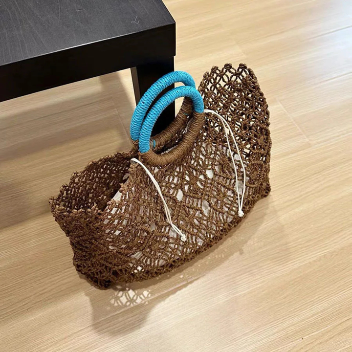 Brown woven shoe with blue and white laces on a wooden floor