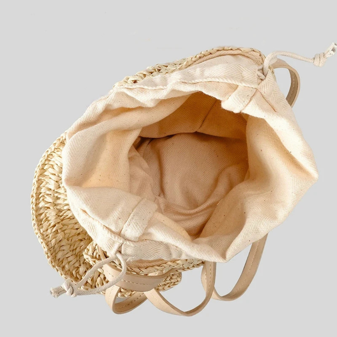 Beige drawstring bag with woven top on a light gray background