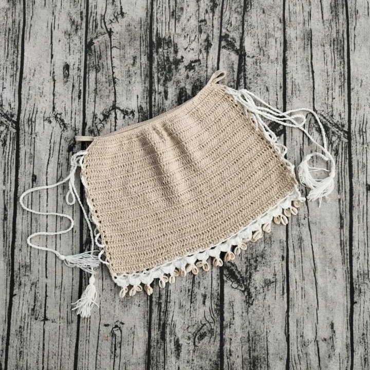 Handmade crochet skirt on a wooden surface