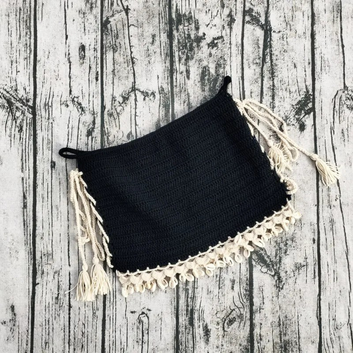 Handmade crochet skirt on a wooden surface