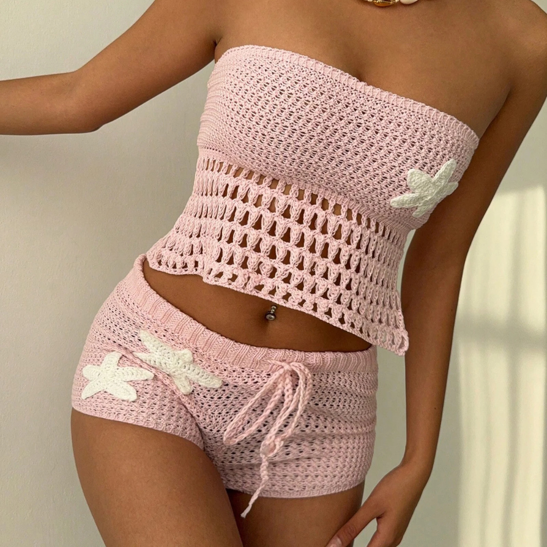 Pink crochet top and shorts set with white starfish details on a neutral background