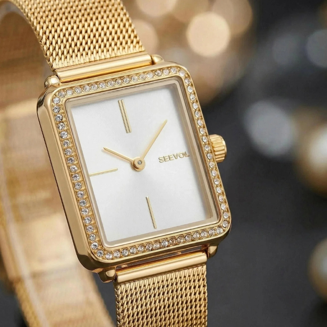 Gold watch with diamond-studded bezel on a blurred background