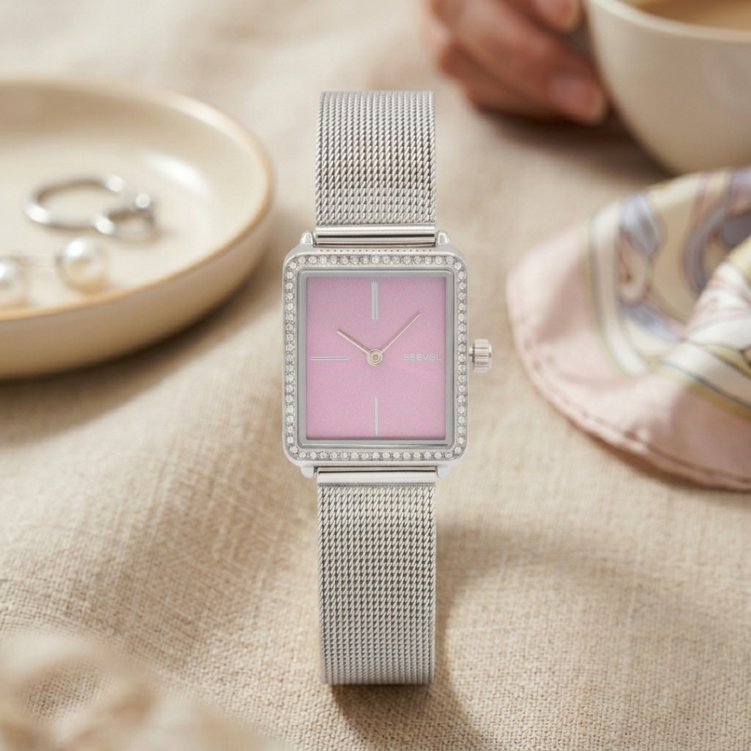 Silver watch with purple face on a beige surface