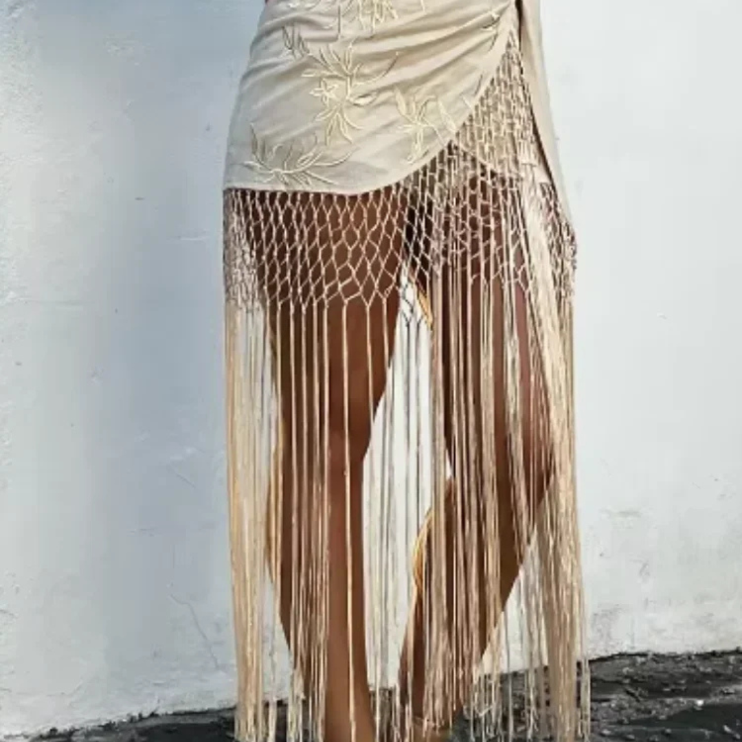 Apricot fringe skirt with floral embroidery on a plain background