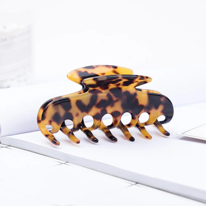 Dark patterned hair comb on a white surface
